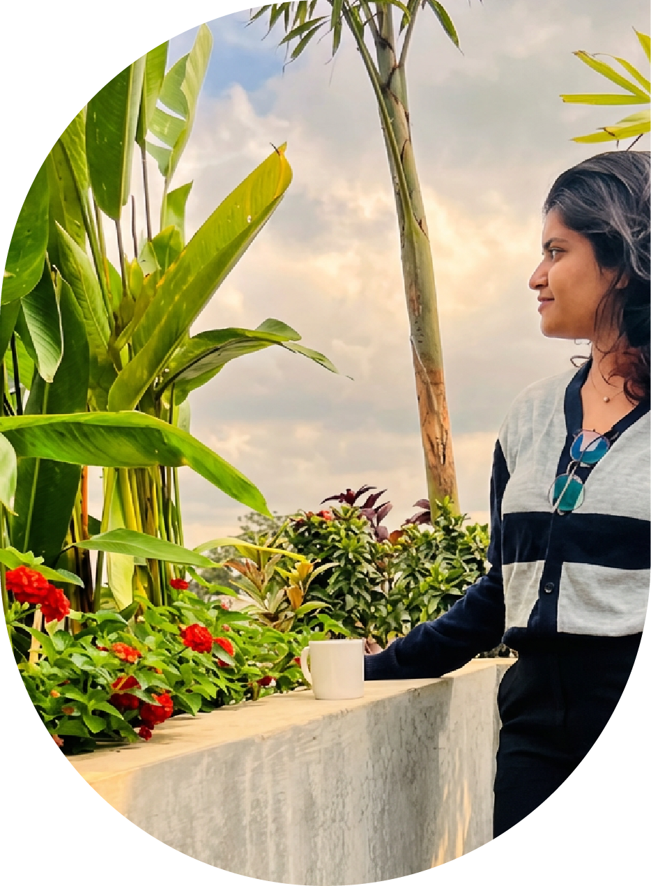 A female employee having tea break and enjoying greenery in cafeteria